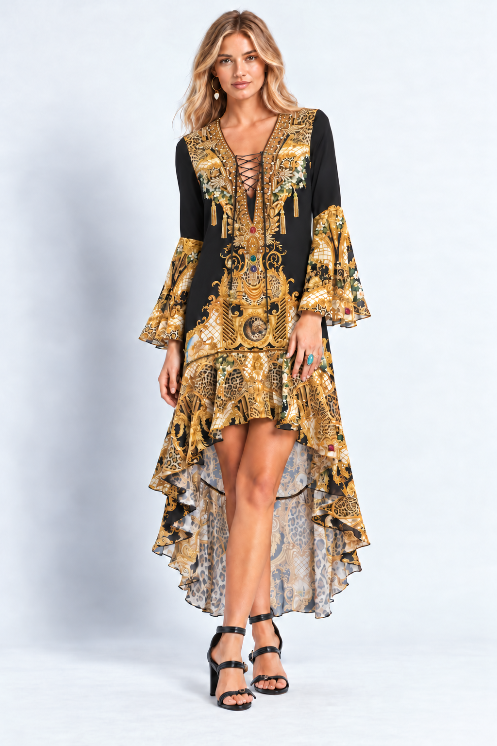 Full-length front view of the Midnight Romance High-Low Dress with Sleeves, showing its black-and-gold print and cascading hem