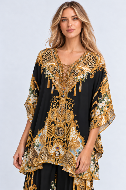 Front view of the Midnight Romance Butterfly Top with an embellished lace-up V-neckline and black-and-gold print