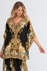 Midnight Romance Butterfly Top showing its flowing butterfly sleeves and ornate gold, leopard and floral motifs