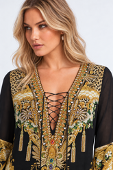Close-up of the crystal-embellished lace-up neckline and ornate print on the Midnight Romance High-Low Dress with Sleeves