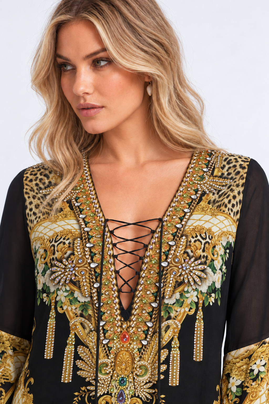 Close-up of the crystal-embellished lace-up neckline and ornate print on the Midnight Romance High-Low Dress with Sleeves