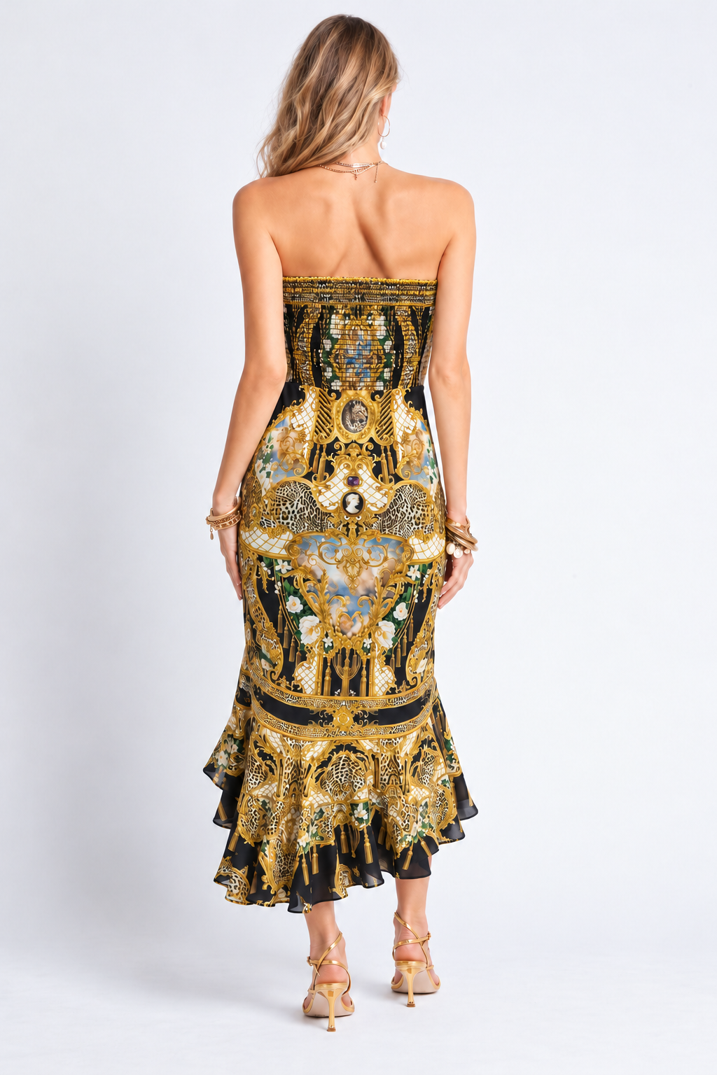 Back view of the Midnight Romance gold and black printed midi dress showing the shirred bodice and frilled hem