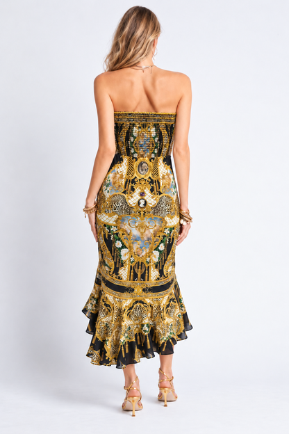 Back view of the Midnight Romance gold and black printed midi dress showing the shirred bodice and frilled hem